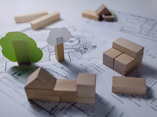 Who we work with - demonstration of constuction project with environmental elements using building blocks and models laid out on a planning document